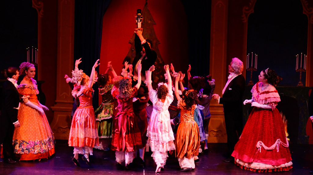 Children surrounding a nutcracker held high